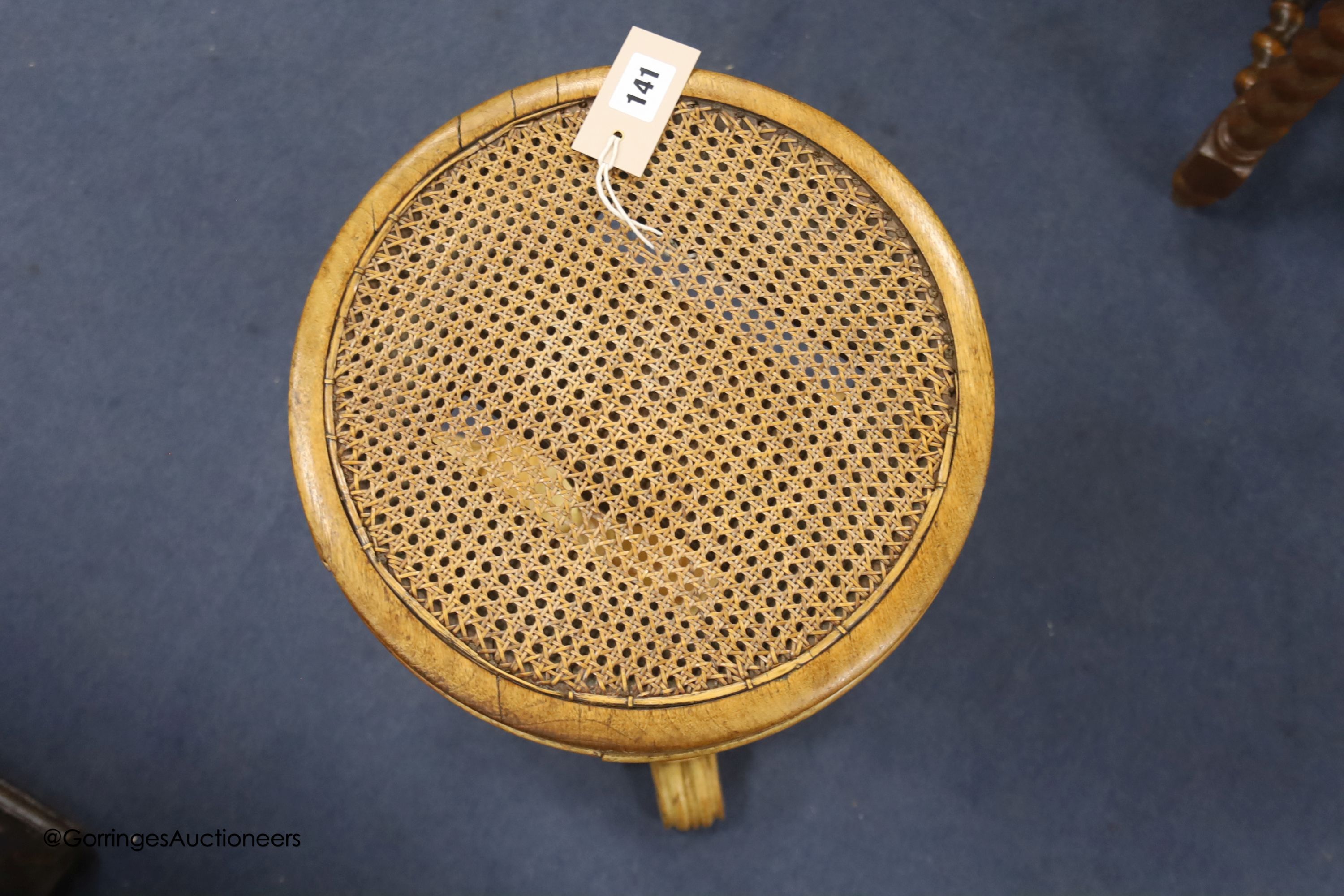 A 19th century bird's eye maple cane seated dressing stool